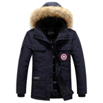 Navy hooded parka with faux fur trim, front zip closure, flap pockets, and a round chest patch