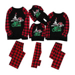 Matching family Christmas pajamas with black tops and red-and-black buffalo plaid sleeves, plus plaid pants; the tops feature a “Merry Christmas” graphic with a Santa hat.