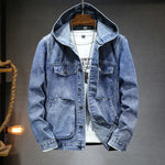 A stylish denim jacket with a hood, layered over a white graphic t-shirt and accessorized with a silver pendant necklace. The jacket features a button-up front, multiple pockets, and a slightly distressed finish, giving it a rugged yet fashionable look. The hoodie detail adds a modern, casual touch, making it perfect for streetwear or casual outings.