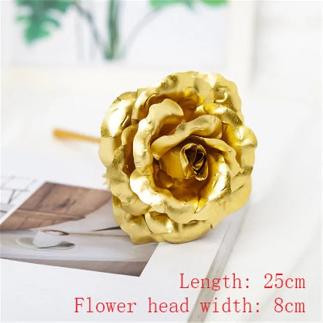 A golden artificial rose with a length of 25cm and a flower head width of 8cm, displayed on a light-colored surface with soft background details.