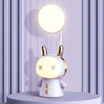 Purple rabbit-shaped table lamp with a round top light, cartoon face, and gold-tone ear detailing.