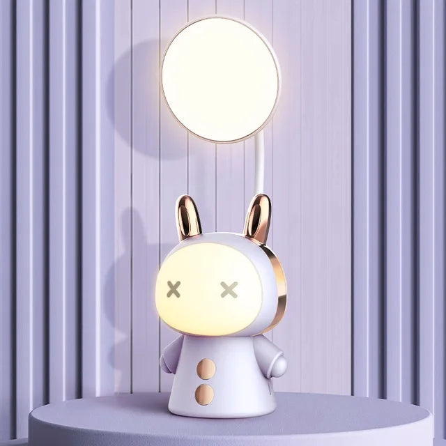 Purple rabbit-shaped table lamp with a round top light, cartoon face, and gold-tone ear detailing.