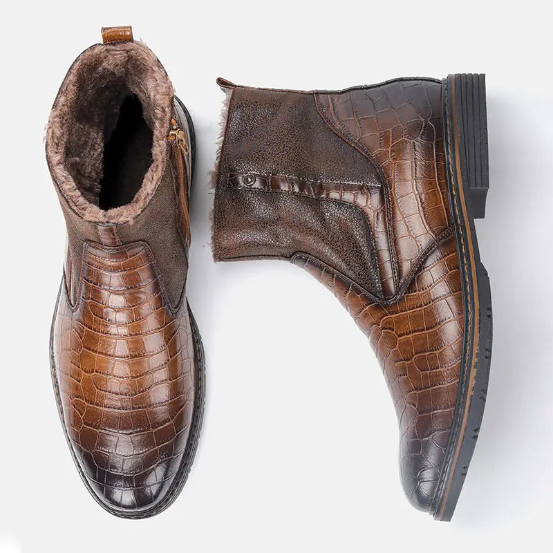 A pair of brown ankle boots with a polished crocodile-embossed finish, side zipper closure, and soft faux-fur lining visible around the collar and inside. The boots combine textured and smooth leather-look panels with sturdy low block soles, giving them a warm, dressy winter style against a plain light background.