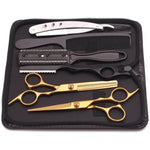 Haircutting tool kit in a zippered case, including two silver hair scissors (one thinning shears), a black comb, and a rainbow-finish straight razor, arranged on a black interior.