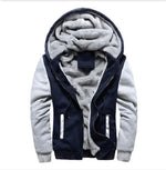A stylish two-tone hoodie with a navy blue body and red sleeves, featuring a thick, plush gray fleece lining for warmth. The hood is large and lined with the same soft material, and the jacket includes a full-length zipper and two front pockets with red accents. Designed for cold weather comfort.