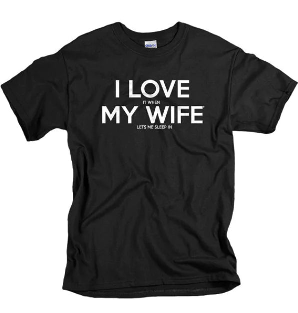 A "I Love It When My Wife Let's Me Sleep In" Biker T-Shirt by STOMART ONLINE with white text that reads, "I LOVE IT WHEN MY WIFE LETS ME SLEEP IN." This short-sleeved biker t-shirt is laid flat, slightly wrinkled. Perfect for biker enthusiasts who appreciate a good laugh.