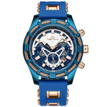 Blue men’s chronograph wristwatch with a blue rubber strap, blue and rose-gold case accents, multiple subdials, and a tachymeter bezel, shown on a white background.
