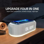 Promotional image of a gray fabric-covered bedside alarm clock with a glowing base and digital display reading “06:00” and “23°C,” with a smartphone resting on top on a wireless charging pad; headline text reads “UPGRADE FOUR IN ONE” with “Alarm clock, temperature, wireless charger, night light.