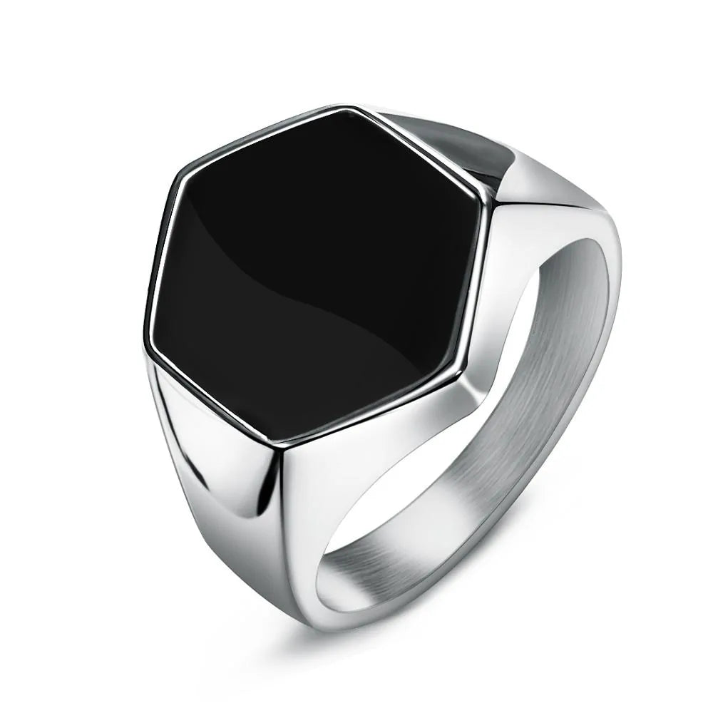 Silver-toned men’s ring featuring a large black hexagonal stone centerpiece.