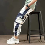 Navy and white cargo joggers with large utility pockets and elastic cuffs.
