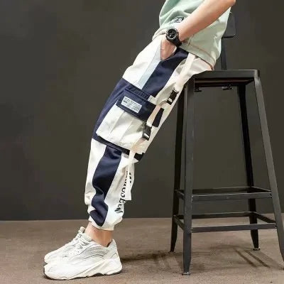 Navy and white cargo joggers with large utility pockets and elastic cuffs.

