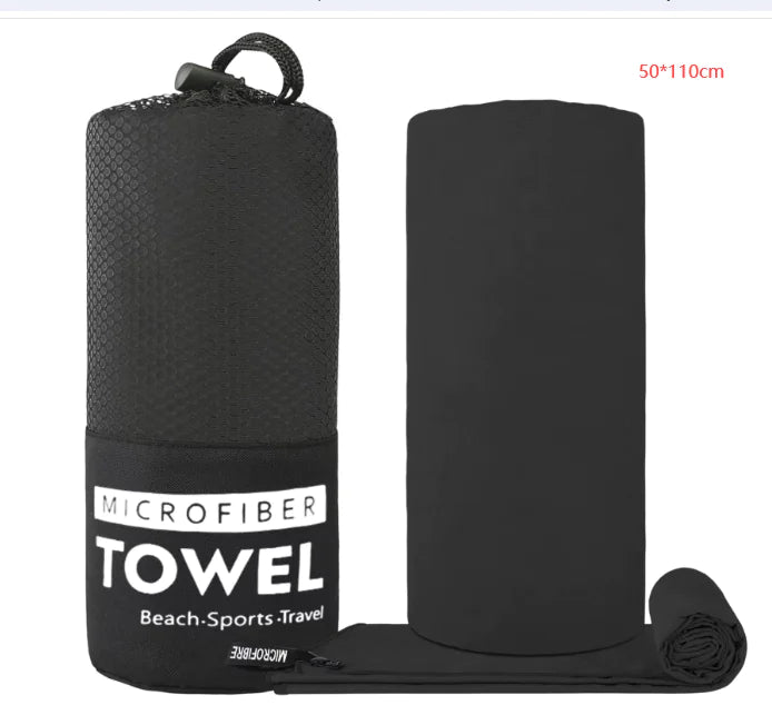 Black microfiber towel set shown with a cylindrical carry bag labeled “MICROFIBER TOWEL Beach·Sports·Travel,” a flat towel marked 50×110 cm, and a rolled towel on a white background.
