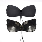 Black adhesive strapless bra set with lace-up front closure and butterfly-shaped lift inserts.
