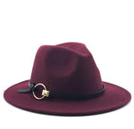 Wide-brim fedora hat with a black band and a gold ring buckle detail, shown on a white background.