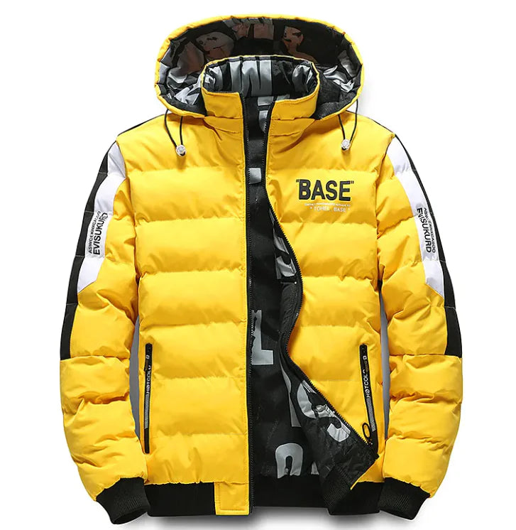 A stylish yellow and black puffer jacket with a hood, featuring the word "BASE" printed on the chest. The jacket has a black and white patterned inner lining, zippered pockets, and white stripe details with text on the sleeves. The hood includes drawstrings for adjustment.