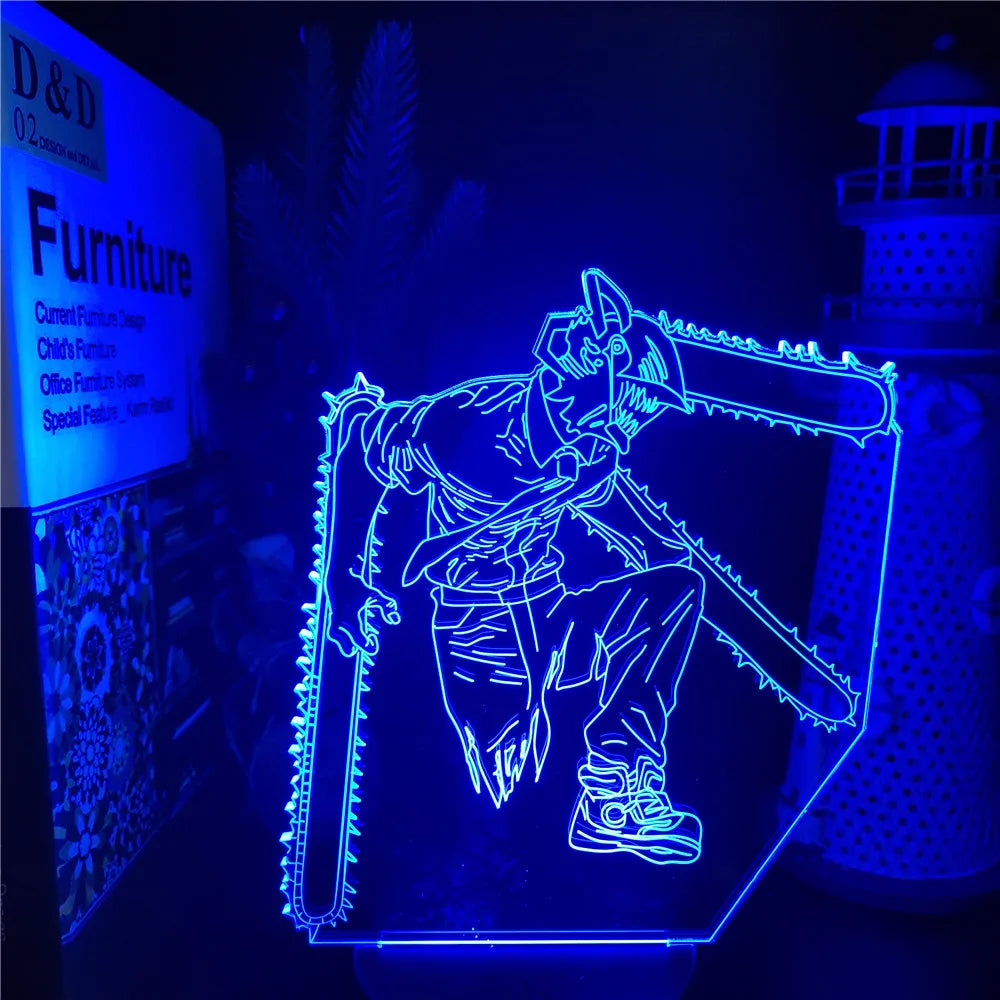 Bright blue LED acrylic night light showing a stylized line-art figure in an action pose with two chainsaw blades, glowing in a dark room with a lighthouse decoration in the background.
