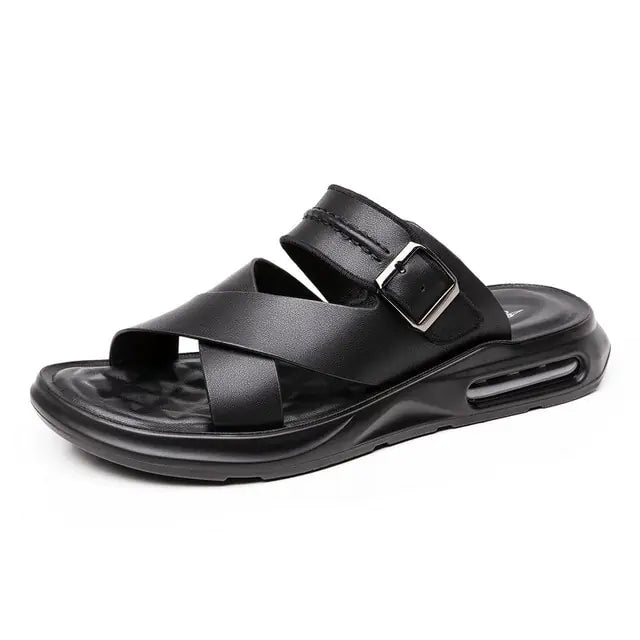 A pair of futuristic open-toe slide sandals with a sleek, curved design and large side cutouts, displayed on a minimalist gray and white background. An inset image shows a beige version of the sandals worn with black socks.