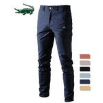 A pair of slim-fit pants with a button closure, belt loops, and side pockets. The fabric appears to be lightweight, suitable for casual or semi-formal wear.