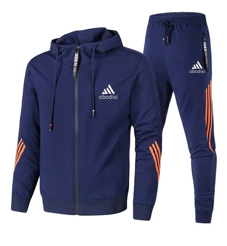 Navy blue two-piece tracksuit set with a zip-up hooded jacket and matching jogger pants, featuring orange stripe accents and an “abodisi” logo on both pieces, shown on a white background.