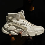 Chunky off-white high-top sneaker with a ribbed sock collar, lace-up front, and oversized sculpted sole.
