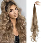 Image showing a woman with voluminous, wavy, light brown hair styled in a half-up, half-down look on the left, and on the right, a long hair extension in a similar shade of light brown.
