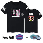 Black graphic T-shirt with printed front-and-back design and bonus BTS-themed accessories.