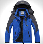 A outdoor jacket with a hood, multiple zippered pockets, and a logo on the chest and sleeve. The jacket appears to be designed for cold or wet weather, with a waterproof or windproof material.