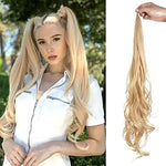 A side-by-side product image showing a blonde woman outdoors wearing long, wavy high pigtails, next to a matching long, wavy blonde ponytail hair extension being held up by a hand on a white background.