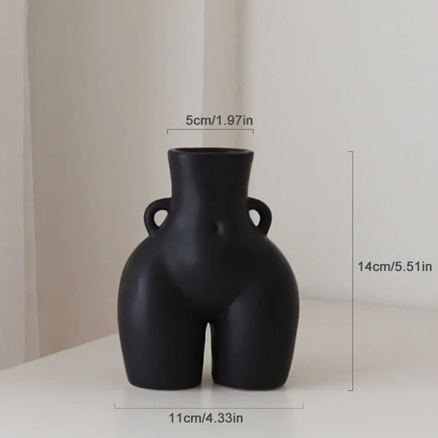 Matte black ceramic vase shaped like a stylized female torso with small side handles, shown with dimensions labeled: 14 cm tall, 11 cm wide, and a 5 cm opening.