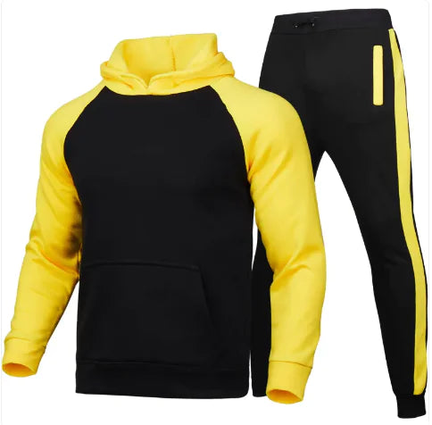 A stylish two-piece men's tracksuit. The set includes a hooded sweatshirt with a kangaroo pocket and long gray sleeves, along with matching jogger pants that have a drawstring waist and gray side panels with zippered pockets. The design offers a sporty yet casual look, ideal for workouts or everyday wear.