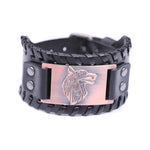 Black braided leather cuff bracelet with snap closure and a rose-gold-toned rectangular plate engraved with a wolf head design, shown on a white background.