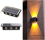 A solar-powered outdoor wall light with a rectangular solar panel and three LED lenses, shown with labeled dimensions on the left and an example installation on a wall on the right, casting warm up-and-down light beams.