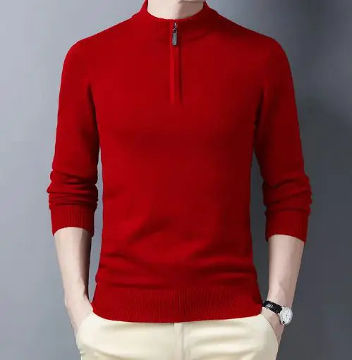A sleek slim-fit sweater with a quarter-zip collar, worn by a male model against a neutral gray background. The sweater features ribbed cuffs and a ribbed hem for a snug and polished fit. The model pairs it with light-colored trousers and a silver wristwatch, creating a refined and sophisticated look.