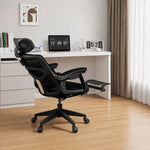 Black office chair in front of a white desk with a tablet and decor items.