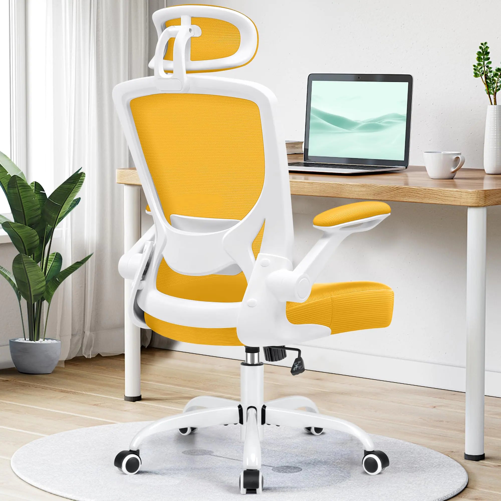 Yellow and white office chair in a home office setting with a desk and laptop.