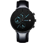 Black analog wristwatch with a black leather strap, blue-accented subdials, and a date window, shown on a white background.
