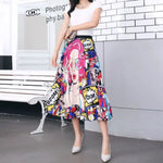 Pleated midi skirt with a gradient design, transitioning from dark black at the waistband to a soft blush pink at the hem, hanging on a black clothing rack next to a vintage-style camera.