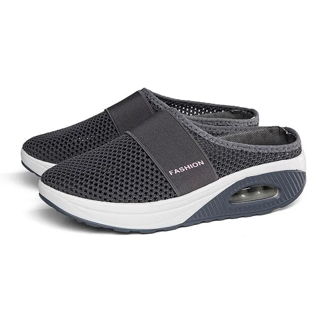 Grey mesh slip-on clogs with elastic strap and cushioned white sole.