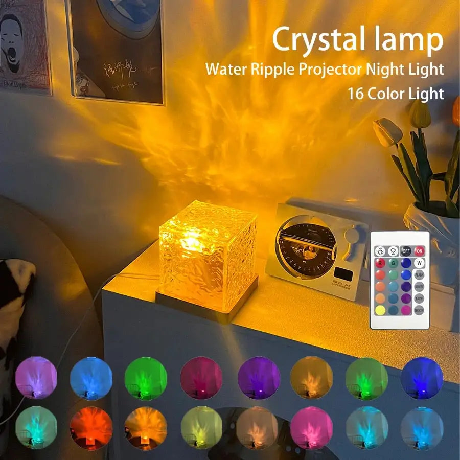 Crystal cube projector lamp casting a warm golden water-ripple light across a room, shown on a bedside table with a remote and multiple colour options.
