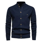 A sophisticated knitted cardigan with a mandarin collar and a button-up front. The cardigan features a textured pattern, ribbed cuffs and hem, and brown-toned buttons that add a stylish contrast. A small embroidered logo is visible on the left chest, enhancing its elegant design