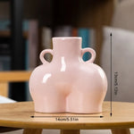 Pink ceramic mini vase with side handles, 13cm tall.
