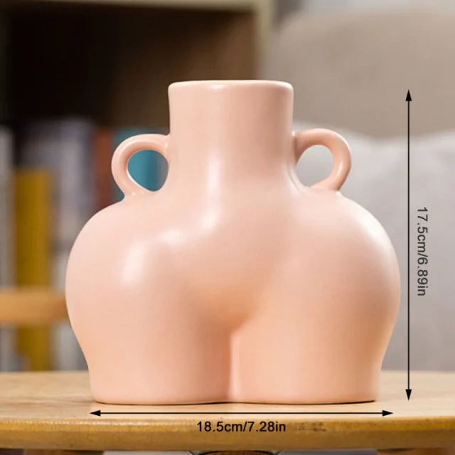 Blush pink body-shaped vase with twin loop handles.