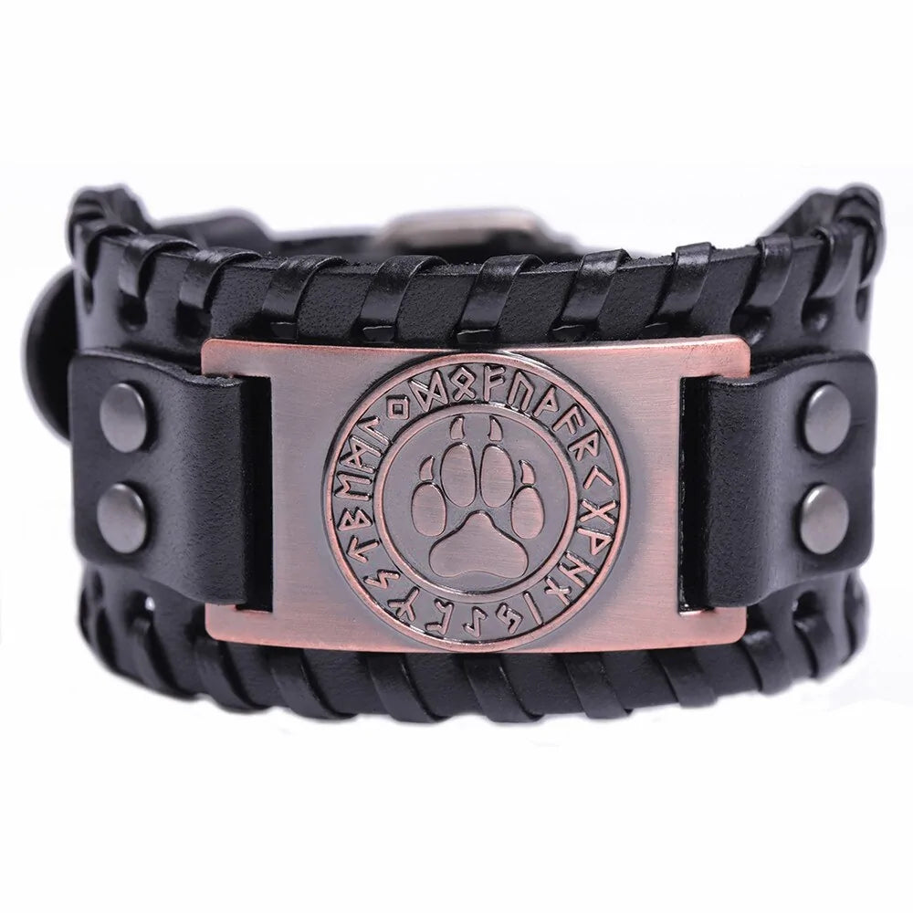 Black braided leather bracelet with snap closures and a copper-toned metal plate featuring a paw print emblem surrounded by rune-like symbols, shown on a white background.