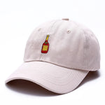 Light beige baseball cap with a small embroidered bottle icon on the front, shown on a white background.