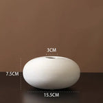 White ribbed ceramic vase.