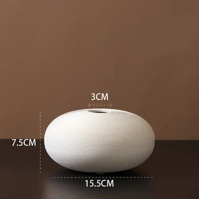 White ribbed ceramic vase.