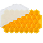 Green silicone ice cube tray with a honeycomb pattern of hexagonal compartments, shown on a white background.

