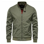 A stylish olive green bomber jacket with a zip-up front, ribbed cuffs, and hem. The jacket features a high collar with a snap button closure and a contrasting red inner lining. It has a modern, slim-fit design with two zippered side pockets, offering a trendy and functional outerwear option.