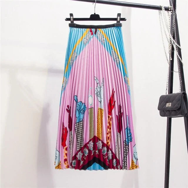 Pleated midi skirt with a gradient design, transitioning from dark black at the waistband to a soft blush pink at the hem, hanging on a black clothing rack next to a vintage-style camera.