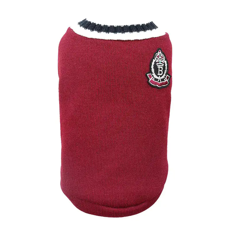 A stylish gray pet sweater with a white and black ribbed collar, featuring a small embroidered crest patch on the upper back.